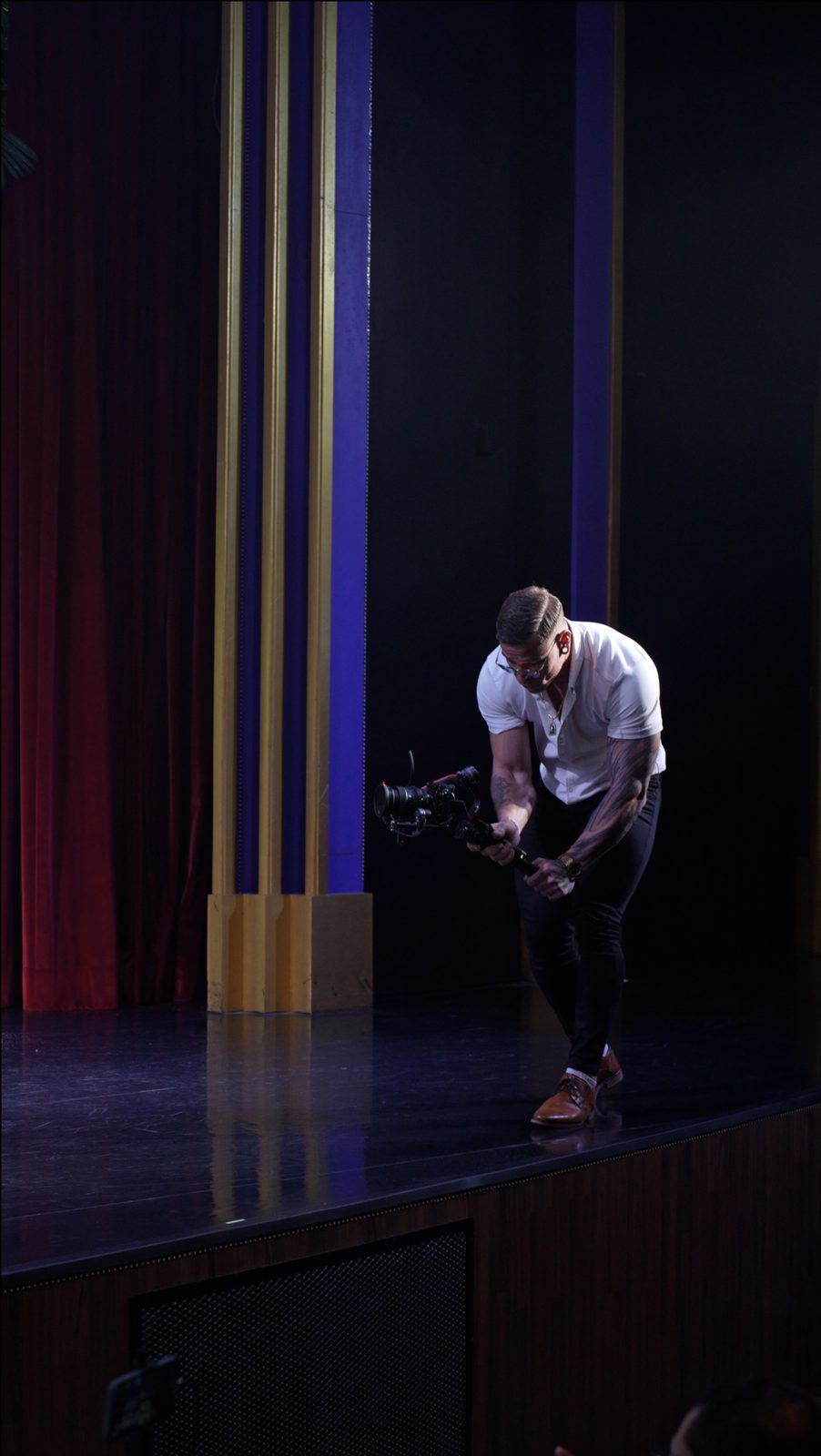 Lars Schubart on stage with a cinema camera